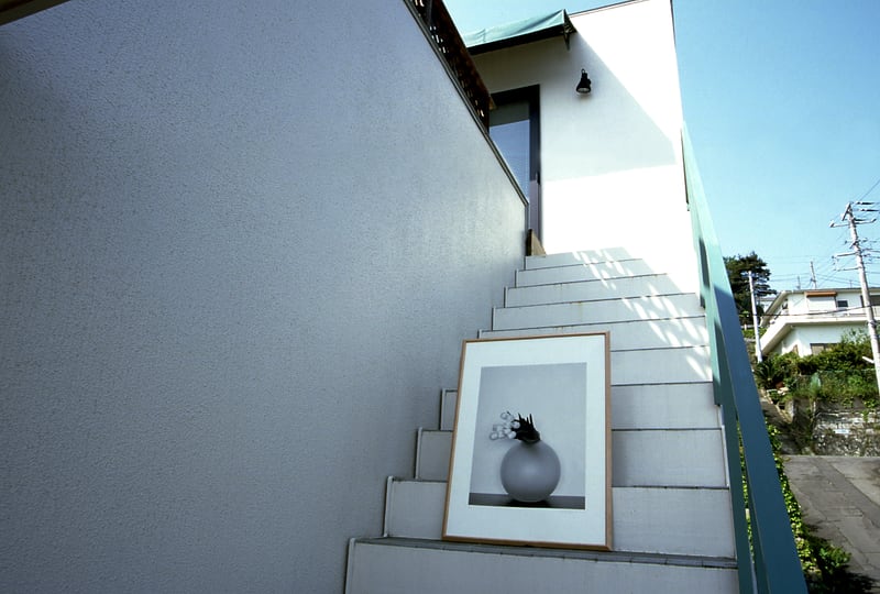 A framed print on the outside stairs